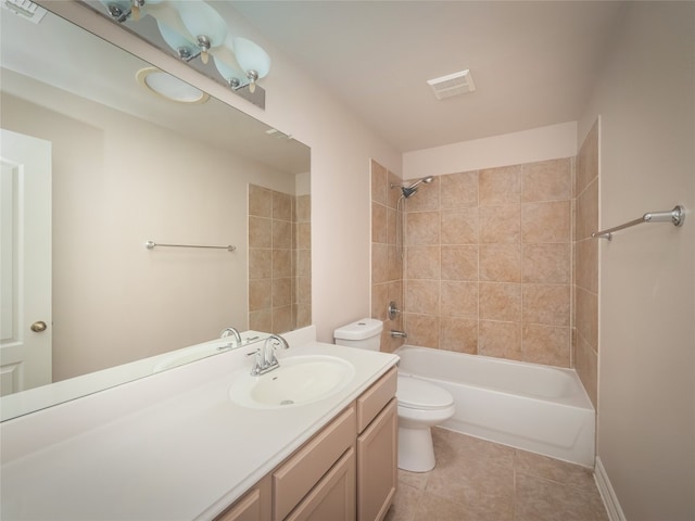 full bathroom featuring vanity, tile patterned flooring, toilet, and tiled shower / bath