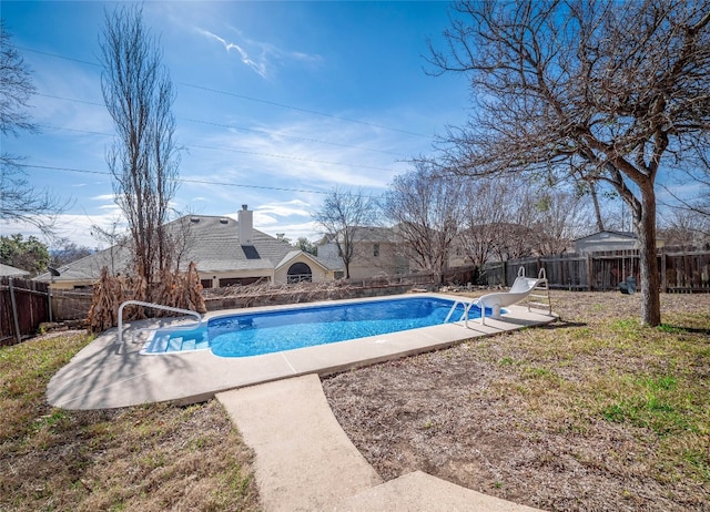 view of swimming pool with a patio area and a water slide