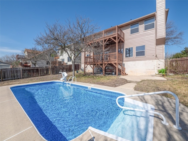 view of pool featuring a patio and a wooden deck