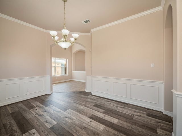 unfurnished dining area featuring a chandelier, crown molding, and dark hardwood / wood-style floors