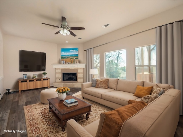 living room with ceiling fan, plenty of natural light, and dark hardwood / wood-style flooring