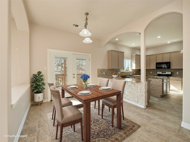 dining space with sink and french doors