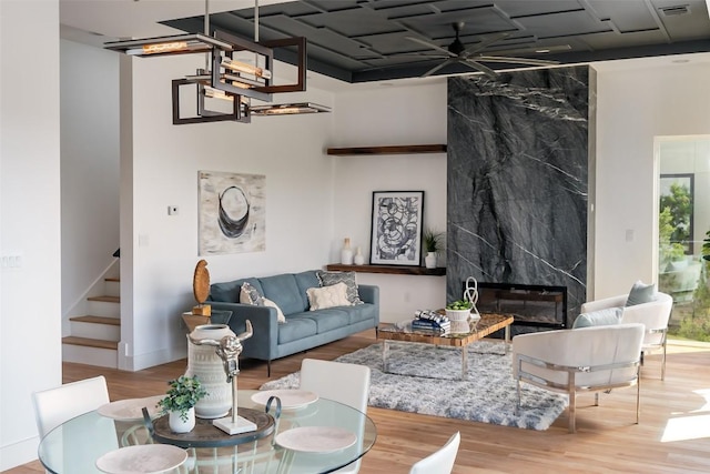 14413 Cochise Trl, Austin, TX 78734 - living room featuring a high end fireplace, stairs, wood finished floors, and ceiling fan