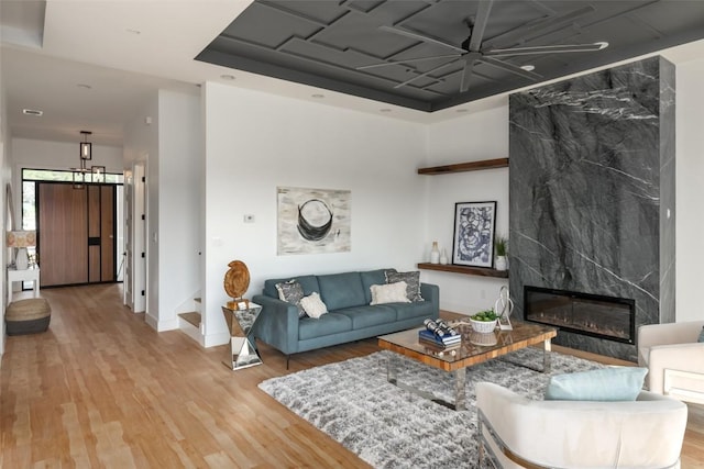 14413 Cochise Trl, Austin, TX 78734 - living room featuring wood finished floors, a premium fireplace, a ceiling fan, and stairway