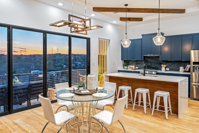 14413 Cochise Trl, Austin, TX 78734 - dining space featuring light wood-type flooring, beam ceiling, a chandelier, recessed lighting, and a towering ceiling