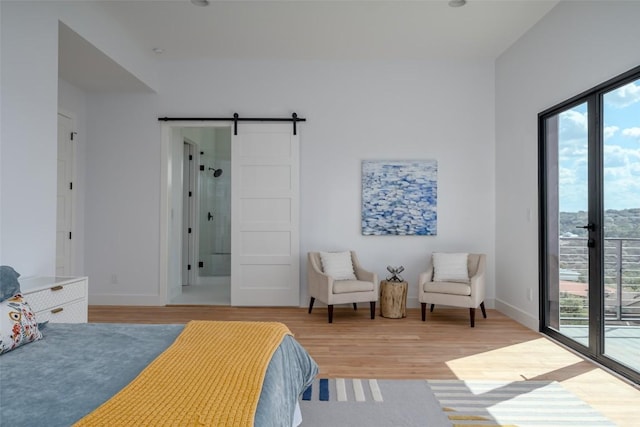 14413 Cochise Trl, Austin, TX 78734 - bedroom with access to exterior, light wood-style floors, and a barn door