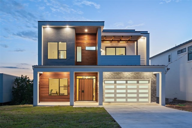14413 Cochise Trl, Austin, TX 78734 - contemporary home with concrete driveway, a metal roof, stone siding, an attached garage, and a front lawn