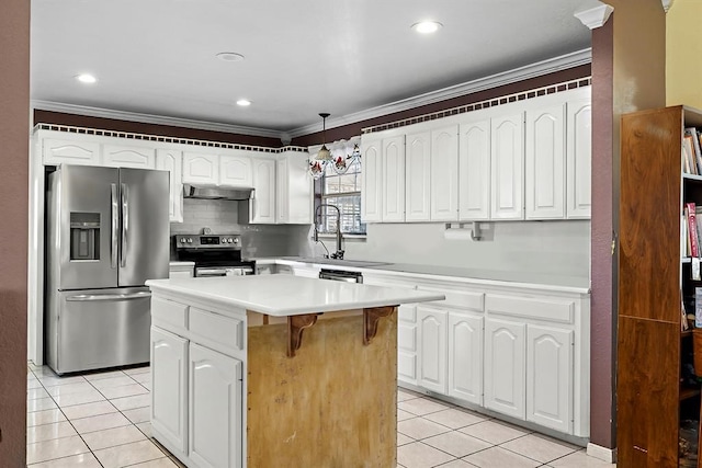 kitchen featuring appliances with stainless steel finishes, light tile patterned floors, hanging light fixtures, and a center island