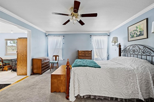 carpeted bedroom with ceiling fan and ornamental molding