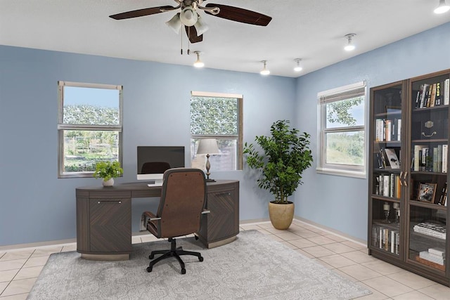 tiled office space featuring ceiling fan