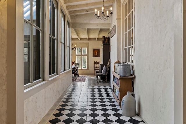 hall with beamed ceiling, a notable chandelier, and tile patterned floors