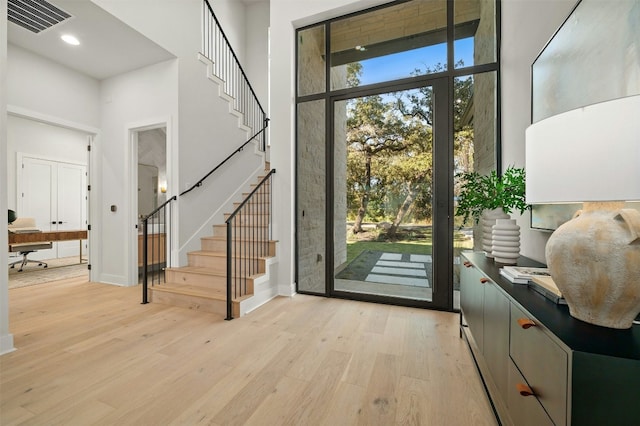 1339 Allen Rd, Austin, TX 78746 - foyer entrance featuring a high ceiling, stairway, light wood-style flooring, and recessed lighting