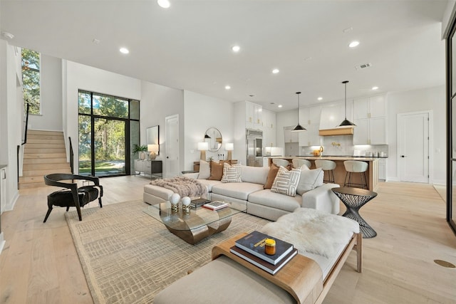 1339 Allen Rd, Austin, TX 78746 - living room with light wood-style flooring, stairway, and recessed lighting