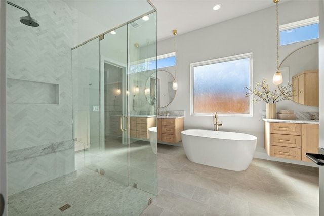 1339 Allen Rd, Austin, TX 78746 - bathroom with a shower stall, vanity, a freestanding tub, and recessed lighting