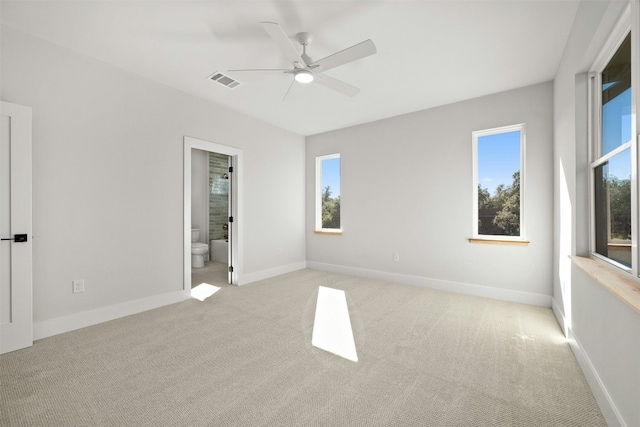 1339 Allen Rd, Austin, TX 78746 - unfurnished bedroom featuring light colored carpet, multiple windows, and ensuite bath