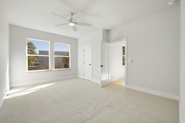 unfurnished bedroom featuring ceiling fan and light colored carpet