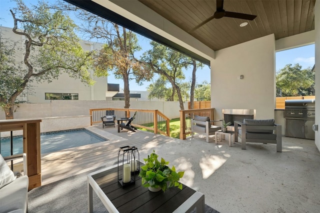 view of patio / terrace with an outdoor living space, ceiling fan, and grilling area