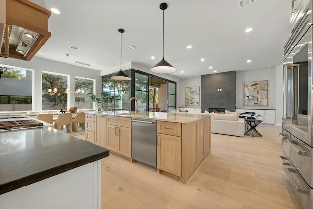 1339 Allen Rd, Austin, TX 78746 - kitchen with light brown cabinets, stainless steel dishwasher, light wood-style floors, recessed lighting, and high end refrigerator