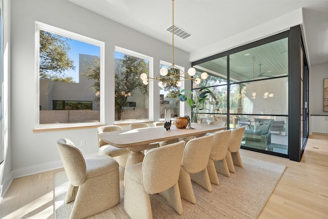 dining room featuring light hardwood / wood-style flooring and a chandelier