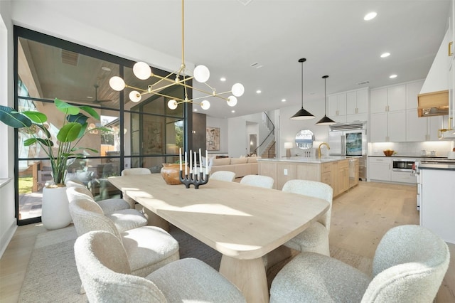 1339 Allen Rd, Austin, TX 78746 - dining space with light wood finished floors, a chandelier, and recessed lighting