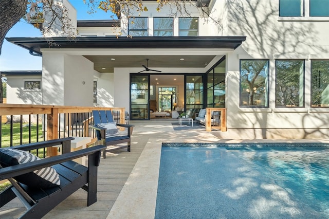 1339 Allen Rd, Austin, TX 78746 - rear view of house with stucco siding, an outdoor pool, a ceiling fan, and a wooden deck