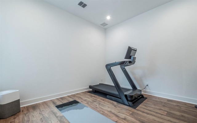 exercise room with hardwood / wood-style flooring