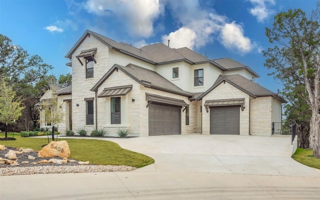 view of front of house with driveway, stone siding, a front lawn, and roof with shingles