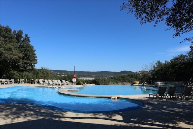 view of pool featuring a patio area and a mountain view