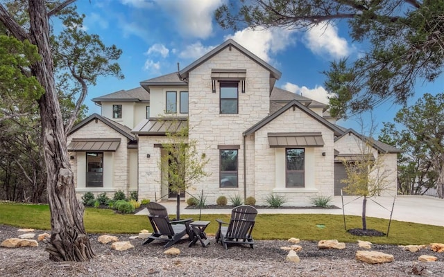 5408 Destination Way, Jonestown, TX 78645 - view of front of home featuring stone siding, roof with shingles, a front yard, and a standing seam roof