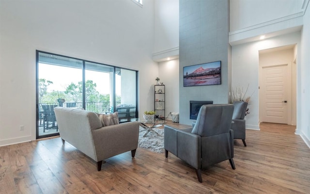 5408 Destination Way, Jonestown, TX 78645 - living area with a high ceiling, wood finished floors, and a tiled fireplace