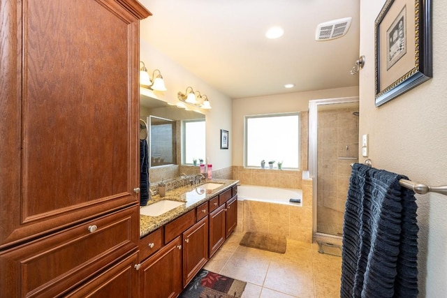 bathroom with a bath, a sink, visible vents, and tile patterned floors