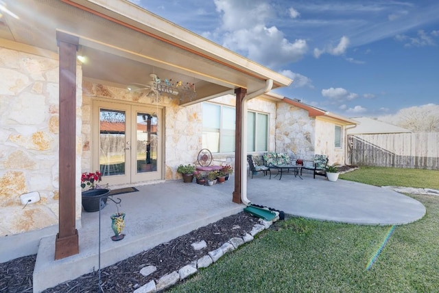 view of patio / terrace with a ceiling fan, french doors, and fence