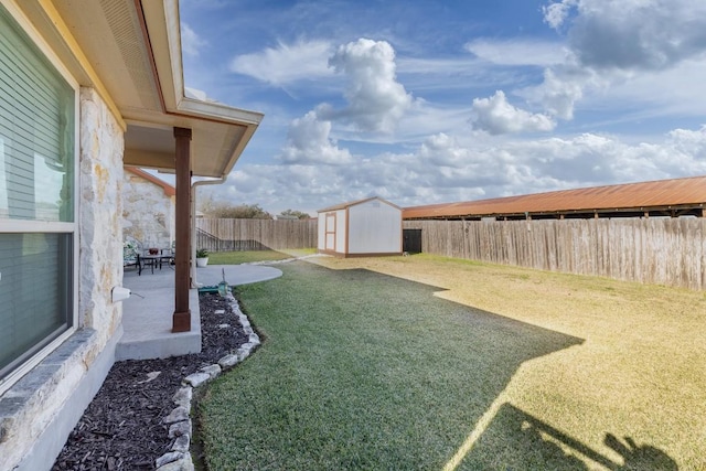 view of yard featuring a patio area, a shed, an outdoor structure, and a fenced backyard