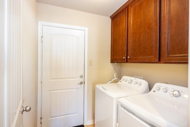 laundry area with washing machine and dryer and cabinet space