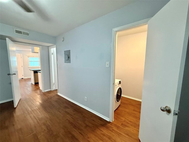 interior space featuring wood finished floors, visible vents, baseboards, electric panel, and washer / clothes dryer