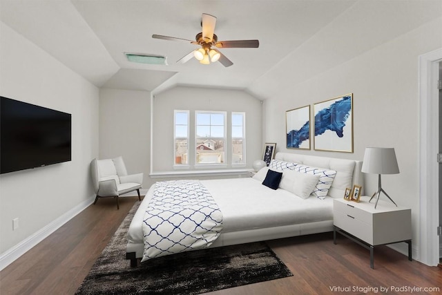 bedroom with ceiling fan, vaulted ceiling, and dark wood-type flooring