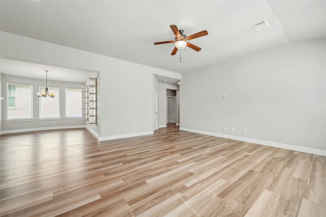 unfurnished living room with ceiling fan with notable chandelier, light wood-type flooring, and vaulted ceiling