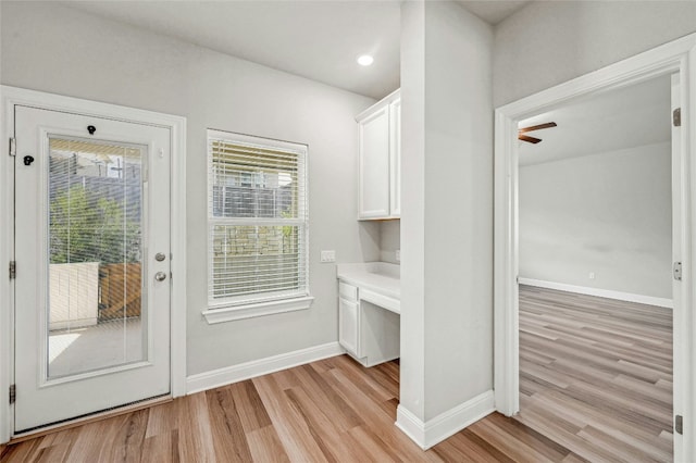 doorway featuring light hardwood / wood-style floors and built in desk