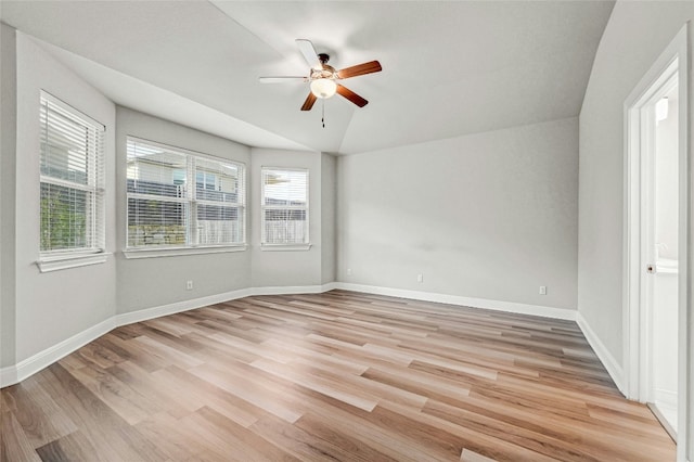 unfurnished room with light hardwood / wood-style flooring, ceiling fan, and vaulted ceiling