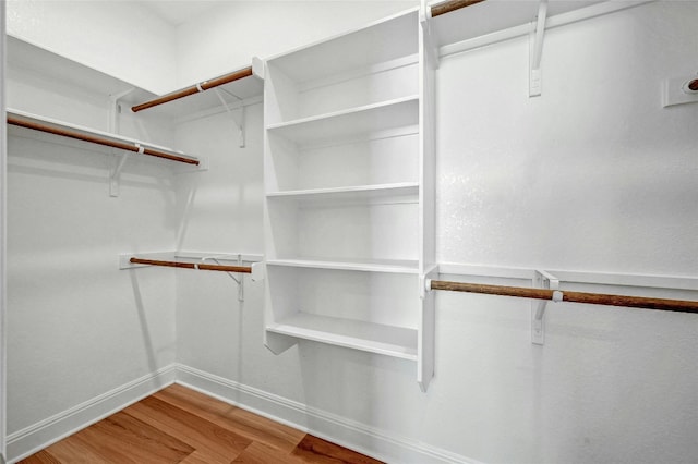 spacious closet with hardwood / wood-style floors