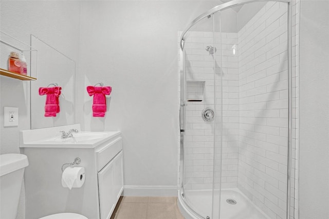 bathroom featuring vanity, tile patterned flooring, toilet, and a shower with shower door