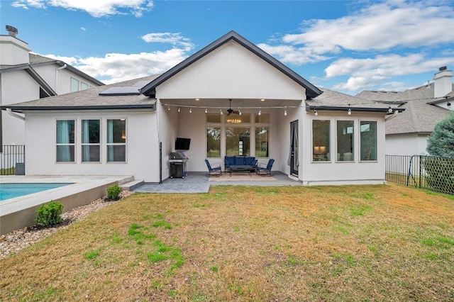 back of property featuring a patio area, outdoor lounge area, a lawn, and ceiling fan