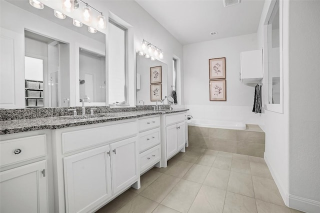 bathroom with tile patterned floors, independent shower and bath, and vanity