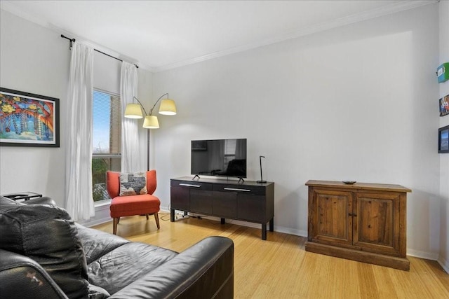 living room with light hardwood / wood-style floors and crown molding