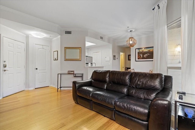 living room with ornamental molding and hardwood / wood-style floors