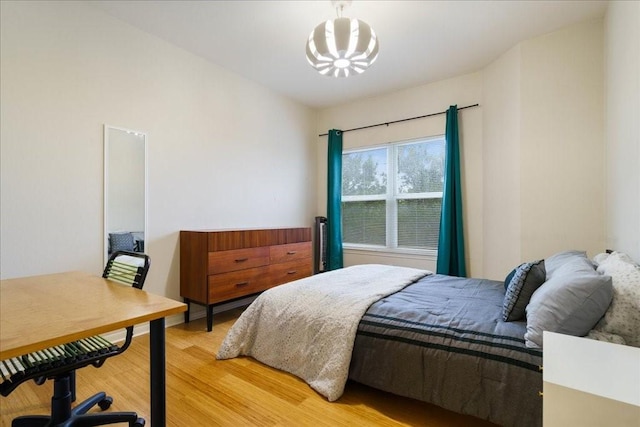 6000 Shepherd Mountain Cv Unit 1818, Austin, TX 78730 - bedroom featuring light wood-style flooring and a chandelier
