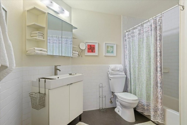 full bathroom featuring tile walls, toilet, vanity, and shower / tub combo