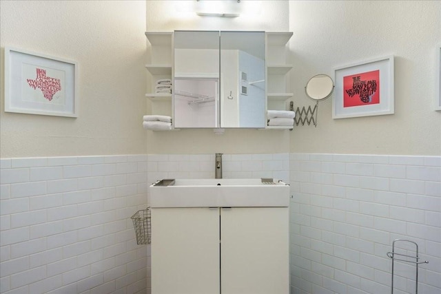 6000 Shepherd Mountain Cv Unit 1818, Austin, TX 78730 - bathroom featuring tile walls, vanity, and wainscoting