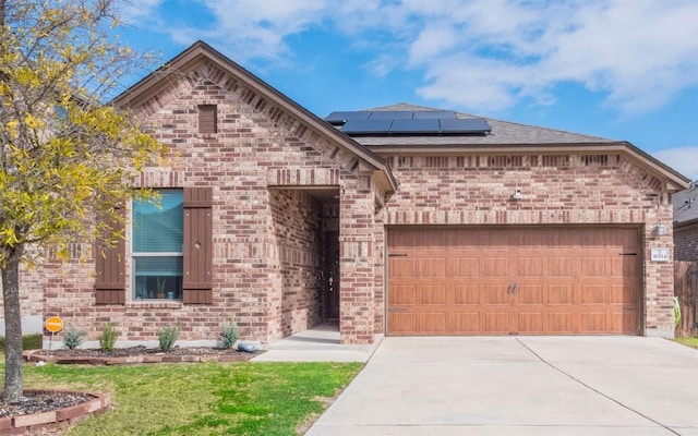 view of front of house with solar panels and a garage