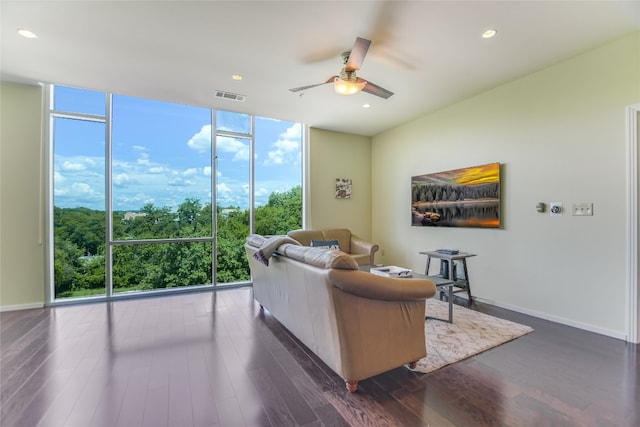 living room featuring dark hardwood / wood-style flooring, ceiling fan, and expansive windows